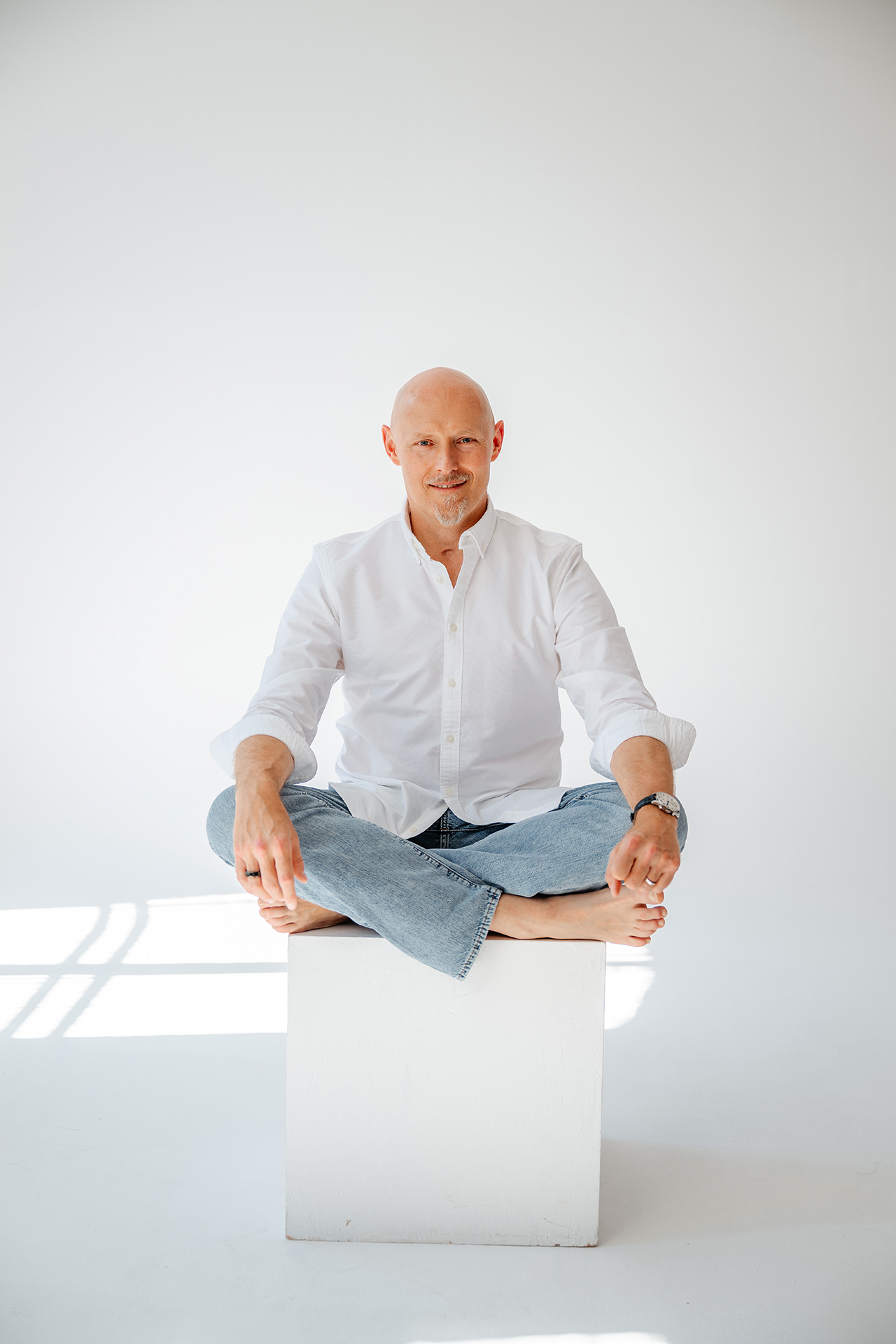 Dr. Piechowski sitting cross-legged in a bright, quiet studio